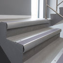 Mill Aluminium bullnose stair nosing with Nimbus Castellated PVC infill, fitted to concrete steps in a commercial stairwell