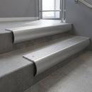 Mill Aluminium bullnose stair nosing with Polished Aluminium infill, fitted to concrete steps in a commercial stairwell