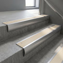 Mill Aluminium bullnose stair nosing with Porth Stone Castellated PVC infill, fitted to concrete steps in a commercial stairwell