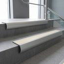 Mill Aluminium bullnose stair nosing with Porth Stone Smooth Textured PVC infill, fitted to concrete steps in a commercial stairwell