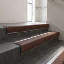 Mill Aluminium bullnose stair nosing with Rustic Castellated PVC infill, fitted to concrete steps in a commercial stairwell
