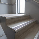 Aluminium bullnose stair nosing with Nimbus Castellated PVC infill, fitted to concrete steps in a commercial stairwell