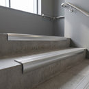 Aluminium bullnose stair nosing with Polished Aluminium infill, fitted to concrete steps in a commercial stairwell