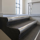 Polished Aluminium bullnose stair nosing with Granite Castellated PVC infill, fitted to concrete steps in a commercial stairwell
