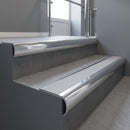 Polished Aluminium bullnose stair nosing with Light Grey Smooth Textured PVC infill, fitted to concrete steps in a commercial stairwell
