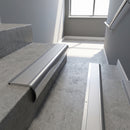 Polished Aluminium bullnose stair nosing with Plain Mill Aluminium infill, fitted to concrete steps in a commercial stairwell