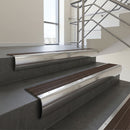 Polished Aluminium bullnose stair nosing with Peat Castellated PVC infill, fitted to concrete steps in a commercial stairwell