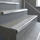 Polished Aluminium bullnose stair nosing with Polar Grey Smooth Textured PVC infill, fitted to concrete steps in a commercial stairwell