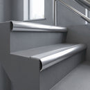 Polished Aluminium bullnose stair nosing with Polished Aluminium infill, fitted to concrete steps in a commercial stairwell