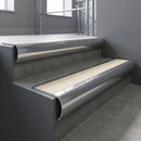 Polished Aluminium bullnose stair nosing with Porth Stone Smooth Textured PVC infill, fitted to concrete steps in a commercial stairwell