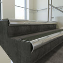 Polished Aluminium bullnose stair nosing with Spruce Castellated PVC infill, fitted to concrete steps in a commercial stairwell