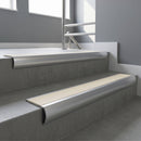 Aluminium bullnose stair nosing with Porth Stone Smooth Textured PVC infill, fitted to concrete steps in a commercial stairwell