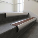 Aluminium bullnose stair nosing with Rustic Castellated PVC infill, fitted to concrete steps in a commercial stairwell