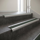 Aluminium bullnose stair nosing with Spruce Castellated PVC infill, fitted to concrete steps in a commercial stairwell