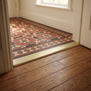 38mm aluminium cover strip in Brushed Brass fitted in a Victorian hallway between oak boards and patterned floor tiles