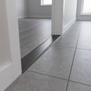 38mm aluminium cover strip in Pewter fitted in an apartment doorway between grey LVT and grey porcelain tile