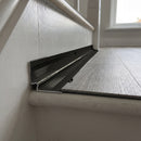 Black anodised aluminium inner corner trim closing the internal angle between an LVT stair tread and the riser