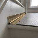 Champagne anodised aluminium inner corner trim closing the internal angle between an LVT stair tread and the riser