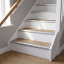 Silver anodised aluminium stair nosing fitted across the full width of oak LVT stair treads