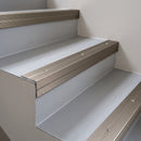 Champagne anodised aluminium 35x35mm ribbed stair nosing fitted to light grey vinyl stair treads
