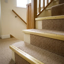 Gold anodised aluminium 35x35mm ribbed stair nosing fitted to beige carpeted stair treads
