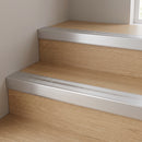Silver aluminium stair nosing with a deep 40mm front face fitted over the nose of two oak laminate stair treads