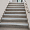 Aluminium rake back stair nosings with ice grey anti-slip inserts fitted to every step of an internal tiled staircase