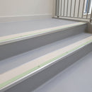 Canvas insert aluminium stair nosing fitted to light grey vinyl treads on a university library staircase