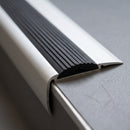 Close-up of the grooved black rubber insert and tapered ramp back edge on the 57mm x 33mm aluminium stair nosing