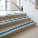 57x55mm rake back aluminium stair nosing with cobalt blue PVC insert and green photoluminescent nose strip fitted on library stairs