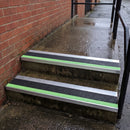 57x55mm external rake back stair nosing with black Tredsafe coarse grit insert and green photoluminescent strip fitted to wet outdoor concrete steps