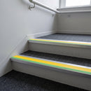 57x55mm rake back aluminium stair nosing with yellow PVC insert and green photoluminescent nose strip fitted on commercial stairs