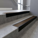 Black Anodised square edge aluminium stair nosing with Bronze Aluminium infill, fitted to a concrete step