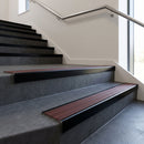 Black Anodised square edge aluminium stair nosing with Claret Castellated infill, fitted to a concrete step