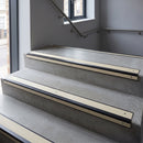 Black Anodised square edge aluminium stair nosing with Ivory Castellated infill, fitted to a concrete step