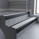 Black Anodised square edge aluminium stair nosing with Light Grey Castellated infill, fitted to a concrete step