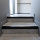 Black Anodised square edge aluminium stair nosing with Light Grey Smooth Textured infill, fitted to a concrete step