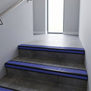 Black Anodised square edge aluminium stair nosing with Mid Blue Castellated infill, fitted to a concrete step