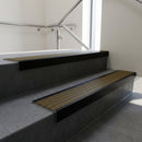 Black Anodised square edge aluminium stair nosing with Olive Castellated infill, fitted to a concrete step