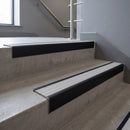 Black Anodised square edge aluminium stair nosing with Polar Grey Castellated infill, fitted to a concrete step