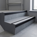 Black Anodised square edge aluminium stair nosing with Polar Grey Smooth Textured infill, fitted to a concrete step