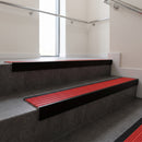 Black Anodised square edge aluminium stair nosing with Poppy Castellated infill, fitted to a concrete step