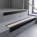 Black Anodised square edge aluminium stair nosing with Porth Stone Castellated infill, fitted to a concrete step