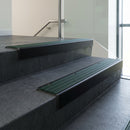 Black Anodised square edge aluminium stair nosing with Spruce Castellated infill, fitted to a concrete step