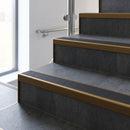 Bronze square edge aluminium stair nosing with Black Castellated infill, fitted to a concrete step