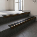 Bronze square edge aluminium stair nosing with Black Smooth Textured infill, fitted to a concrete step