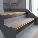 Bronze square edge aluminium stair nosing with Fawn Castellated infill, fitted to a concrete step