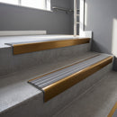 Bronze square edge aluminium stair nosing with Flint Castellated infill, fitted to a concrete step