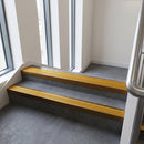 Bronze square edge aluminium stair nosing with Gold Castellated infill, fitted to a concrete step