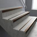 Bronze square edge aluminium stair nosing with Light Grey Castellated infill, fitted to a concrete step